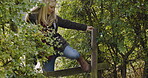 Woman, travel and walking over fence with warning sign for trespassing, rebble or clueless tourist in countryside. Female explorer or traveler taking a walk in forbidden entrance or crossing obstacle