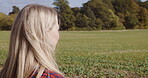 Nature, earth and travel with woman in field for relax, sunshine and breathing fresh air. Environment, growth and summer with face of girl enjoying countryside park for sunset, freedom and happiness