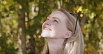Wellness, trees and face of woman with smile enjoying freedom, fresh air and quality time outdoors. Nature, motivation and girl with happy mindset, peace and calm on journey, adventure and holiday