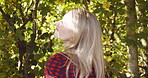 Trees, nature and peace with woman in countryside park for freedom, relax and summer break. Garden, environment and happy with girl enjoying outdoors for carefree, smile and breathing fresh air
