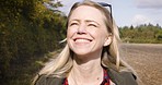 Face, travel and a happy woman walking in field for sightseeing, relax and solo trip on nature background. Smile, peaceful and young female enjoy calm, quiet and satisfied walk in a forest in Mexico 