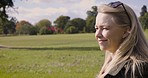 Happy, smile and female on a walk in a field for outdoor fresh air, exercise or alone time. Happiness, nature and mature woman walking in a green garden for wellness or health in summer in Canada.