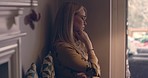 Lonely woman, home and thinking of depression, anxiety and struggle of mental health risk. Depressed, sad and worried female in house with doubt, psychology and crisis of emotions, grief and problems