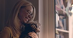 Happy, window and a woman petting her dog while looking at the view from their home in the morning. Smile, kiss or bonding with a female owner and her pet together in their house for animal love