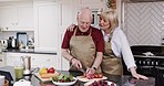 Love, hug and old couple in kitchen with salad for lunch, healthy food and vegetable diet in retirement. Happy woman, senior man in apron and conversation, meal prep and marriage bonding in apartment