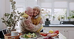 Love, hug and old couple in kitchen with salad for lunch, healthy food and vegetable diet in retirement. Happy woman, senior man in apron and conversation, meal prep and marriage bonding in apartment