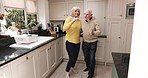 Dance, love and senior couple in kitchen for happiness for bonding, quality time and romance at home. Retirement, marriage and happy elderly man and woman singing, silly dancing and have fun together