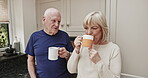 Funny, morning coffee and an old couple in the kitchen of a retirement home, chatting or bonding together. Love, drink or humor with a senior man and woman enjoying caffeine while talking in a house