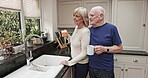 Relax, coffee and love with old couple by window in kitchen for bonding, affectionate and retirement. Morning routine, happy and smile with senior man and woman at home for free time, weekend and tea