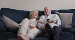Communication, television and relax senior couple talking, speaking or watching tv show, news broadcast or entertainment. Bond, remote control and happy people streaming movie for home quality time
