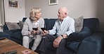 Relax, alcohol and senior couple on a sofa, conversation and chilling at home, talking and relationship. Partners, mature man and old man with red wine, communication and bonding with quality time