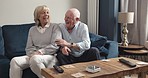 Old couple, laughing and talking on couch in home for conversation, communication and quality time together. Senior man, elderly woman and funny chat to enjoy happy retirement joke in living room