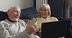 Smartphone, laptop and senior couple discussion about retail online shopping decision, funny choice or retirement discount. Marriage bond, home and elderly people laughing at meme, comedy or joke