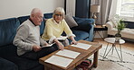Senior couple, paper and documents in home for insurance policy, notes and financial investment. Old man, woman and paperwork of retirement savings, pension planning and discussion for drafting will