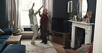 Funny, senior couple and dancing in living room for love, care and quality time together in retirement. Happy old man, elderly woman and playful dance to music with happiness, smile and joy at home