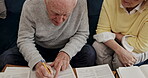 Senior couple in home reading budget, documents and life insurance policy in retirement. Elderly man, woman and paperwork of savings, pension planning and discussion of will, admin and legal contract