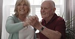 Happy old couple, dance and hug in home for love, romance and celebrate special moment together in retirement. Senior man, elderly woman and dancing to music with happiness, quality time and freedom