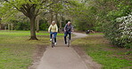 Health, senior couple and riding bicycle for exercise, fitness and wellness being healthy together in nature. Retirement, man and woman enjoy bike ride in a park or garden
