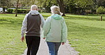 Health, senior couple and walking for exercise, fitness and wellness being healthy together in nature. Retirement, man and woman enjoy workout in a park or garden