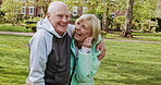 Happy senior couple outdoor and in love, spending quality time together in nature. Retirement and man and woman enjoy a relax day in a park or garden