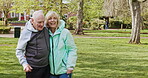 Happy senior couple outdoor and in love, spending quality time together in nature. Retirement and man and woman enjoy a relax day in a park or garden