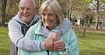 Happy senior couple outdoor and in love, spending quality time together in nature. Retirement and man and woman enjoy a relax day in a park or garden
