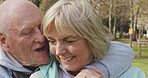 Happy senior couple outdoor and in love, spending quality time together in nature. Retirement and man and woman enjoy a relax day in a park or garden