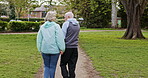 Health, senior couple and walking for exercise, fitness and wellness being healthy together in nature. Retirement, man and woman enjoy workout in a park or garden