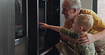 Baking, grandfather and child with food in the kitchen of a house. Elderly man preparing a sweet dessert with his grandson at home