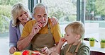 Cooking, grandparents and child with breakfast food in the kitchen of a house. Elderly man and woman preparing a healthy meal with their grandson at home