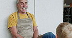 Old man and grandson bonding together in the kitchen with conversation and support at home. Love, relationship and senior grandfather relax with discussion and family advice