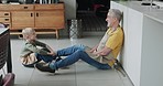 Old man and grandson bonding together in the kitchen with conversation and support at home. Love, relationship and senior grandfather relax with discussion and family advice