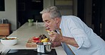Cooking, recipe and senior man taste breakfast food in the kitchen of a house. Elderly person preparing a healthy lunch on the stove at home
