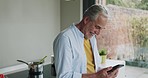 Cooking, recipe and senior man with phone for online breakfast food in the kitchen of a house. Elderly person reading on the internet for healthy lunch