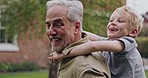 Senior man and grandson bonding together in a garden with fun and love. Playing, relationship and happy grandfather having family quality time
