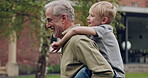 Senior man and grandson bonding together in a garden with fun and love. Playing, relationship and happy grandfather having family quality time