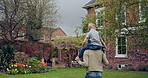 Senior man and grandson bonding together in a garden with fun and love. Playing, relationship and happy grandfather having family quality time