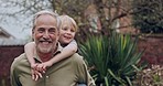 Senior man and grandson bonding together in a garden with fun and love. Playing, relationship and happy grandfather having family quality time