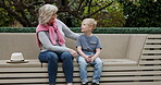 Senior woman and grandson bonding together in a garden with conversation and support. Love, relationship and advice with a hug from grandmother to relax during discussion with family