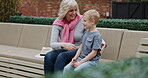 Senior woman and grandson bonding together in a garden with conversation and support. Love, relationship and advice with a hug from grandmother to relax during discussion with family