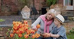 Woman with boy working in garden or backyard with grandmother. Senior woman and child with plants for sustainability, love and nature with family outdoor, gardening flowers  at home