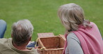 Couple, love in a garden on a picnic for a romantic holiday or vacation in spring. Happy senior man and woman bonding and relax in retirement
