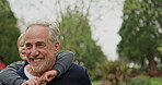 Grandfather piggyback young boy in garden, park and outdoor for love, care and fun. Senior man carrying happy kid while walking, talking and pointing in nature