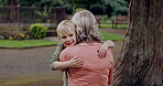 Young boy running to hug grandmother in park, garden and outdoor for love, care and support. Excited kid, senior woman and embrace with happiness together