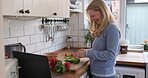 Reading, tablet for cooking and woman in kitchen with recipe or woman to cut vegetables with knife on board for healthy dinner. Mobile app, instructions and meal with nutrition or online diet plan