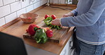 Cooking, vegetables and hands of woman on knife, board in the kitchen and healthy, recipe on tablet, blog and dinner in home.  Mobile app, instructions and meal with nutrition or online diet plan