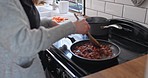 Woman, stove and wellness cooking in kitchen with eating at home feeling hungry with food. House, female person and lunch with frying pan and diet with vegetables and nutrition meal for dinner