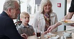 Laughing, grandparents and kid bonding in restaurant together, happy and excited eating at table. Grandmother, grandfather and child in cafe, waiter service at lunch and funny quality time for family