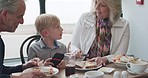 Restaurant, food with grandparents and a boy using his phone in the morning while breakfast food. Family, grandmother and grandfather with their male grandchild in a cafe together for bonding