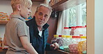 Family, grandfather and boy grandchild in a candy shop together for retail or commercial shopping as customers. Children, bonding and a senior man shopping for sweets with his adorable kid grandson